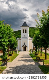 Church of st. John of Nepomuk in Oravsky Podzamok, a nicely renovated Catholic church. View from the walking alley from the front of the building
