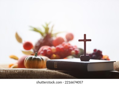 Church Thanksgiving Day bountiful fruit decoration and background with bible and jesus cross
 - Shutterstock ID 2216674057