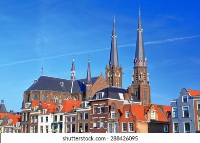 Church towers above traditional buildings by the main square in Delft, Holland 