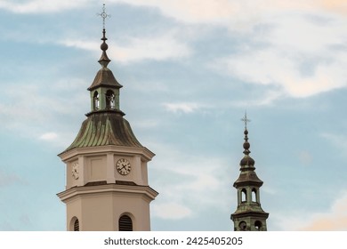 Church towers with copper-plated roofs and crosses on the domes.Towers of a historic church with crosses on top of the roofs, a wagtail bird sits on one of the crosses. An architectural monument .