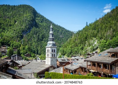 Church and the village of La Clusaz in summer, France
