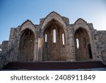 Church of the Virgin Mary of the Burgh with sun peaking through blue skies