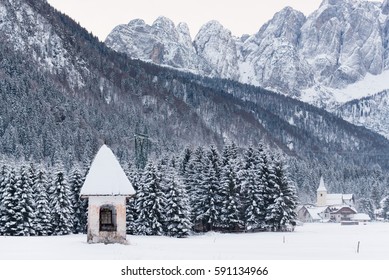 Church votive German tradition. Popular religiosity in Friuli. Winter, snow. - Powered by Shutterstock