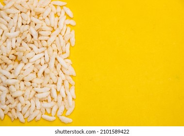 Churmure or murmure or moori, Puffed rice, food ingredient. Traditional food isolated on yellow background.