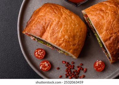 Ciabata with jamon or prosciutto, tomatoes, cheese and lettuce with salt, spices and herbs - Powered by Shutterstock