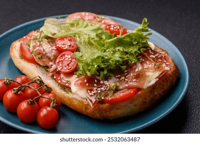 Ciabata with jamon or prosciutto, tomatoes, cheese and lettuce with salt, spices and herbs - Powered by Shutterstock