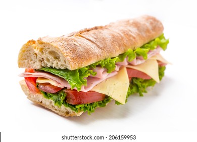 Ciabatta Sandwich with Lettuce, Tomatoes, Ham and Cheese cut in half