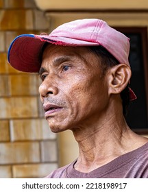 Cibubur, Indonesia, October 22, 2022: A Middle-aged Man In A Pink Hat Standing Still