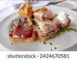 Cicchetto, typical Venetian appetizer, perfect for the whole day both in the morning or as an aperitif in the afternoon. Toasted bread with cold cuts, cheeses, creamed cod or other