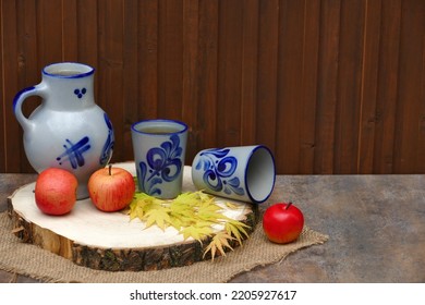 Cider In A Jug In Front Of A Wooden Wall.