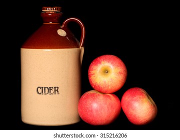 Cider Jug And Red Apples On Black Background