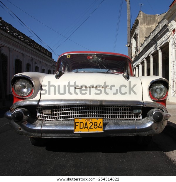CIENFUEGOS, CUBA - FEBRUARY 3, 2011: Classic\
American Chevrolet car parked in the street in Cienfuegos, Cuba.\
Cuba has one of the lowest car-per-capita rates (38 per 1000 people\
in 2008).
