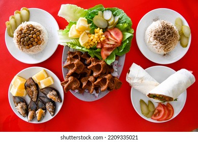 Cig Kofte (raw Meatball) With Lettuce, Tomato, Pickle And Lemon, Hot Chee Kofta. Turkish Local Raw Food Concept.Table Scene Of Assorted Take Out Or Delivery Foods. Top View Of Assorted Turkish Food.