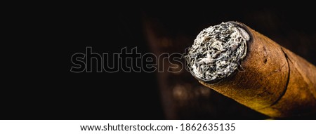 cigar tip detail, isolated on dark background