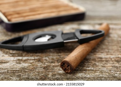 Cigar Wrapped In Tobacco Leaf On Wooden Table, Closeup