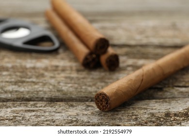 Cigar Wrapped In Tobacco Leaf On Wooden Table, Closeup