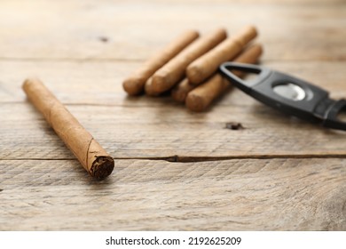 Cigar Wrapped In Tobacco Leaf On Wooden Table. Space For Text