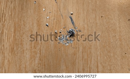 Cigarette ash left on the wooden floor
