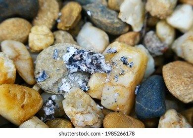 
Cigarette Ash Scattered On The Gravel