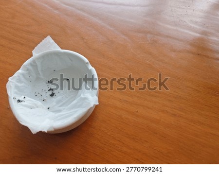 Cigarette ashtray with brown table background