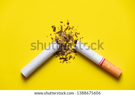 cigarette broken on yellow background and tobacco leaf blast out side with light top to down, modern quitting concept.