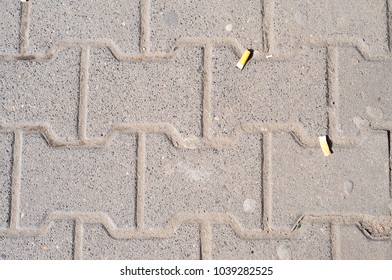 Cigarette Buts On Pavement.