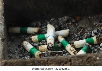 cigarette butts in the ashtray. smoking is a bad habit. nicotine addict. interfere with health - Shutterstock ID 2219823527