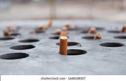 Cigarette butts in a big ashtray