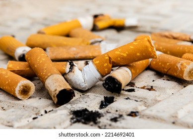 Cigarette. A lot of cigarette butts and matches are lying on the road. Trash - Shutterstock ID 2214692401