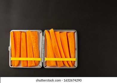 Cigarette case with carrot slices Concept of quitting smoking, healthy lifestyle