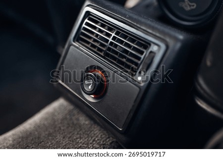 Cigarette lighter socket in old 1990s car interior
