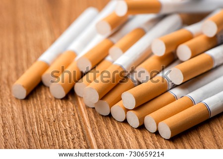 cigarette, cigarette on a wooden background, a pack of cigarettes, a close-up of a cigarette