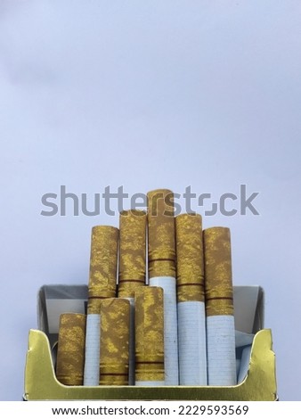 The cigarette sticks poking out of the pack and revealing the golden filter