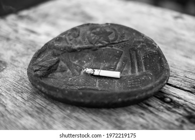 A Cigarette In A Vintage Ashtray On The Table 