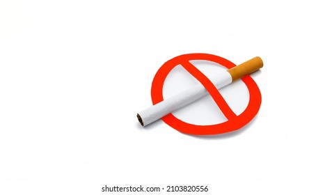 A cigarette without a trademark next to a red forbidden sign on white background, concept of no smoking