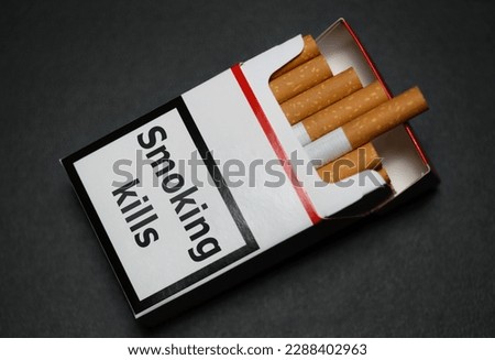 Cigarettes in cigarette box pack packet with smoking kills warning