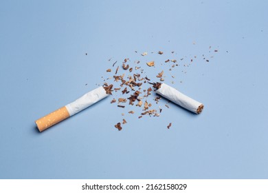 Cigarettes are destroyed on a blue background. Smoking cessation concept. Copy Space - Shutterstock ID 2162158029