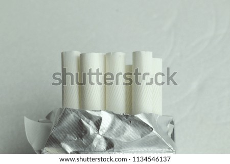 Cigarettes in an envelope on a white background.