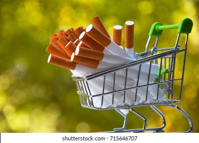 
Cigarettes In A Shopping Cart.Many Cigarettes On An Evil Background