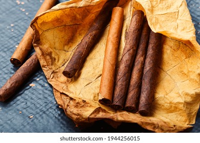 Cigarillos And Dry Tobacco Leaf On Table.Dried Tobacco Leaves