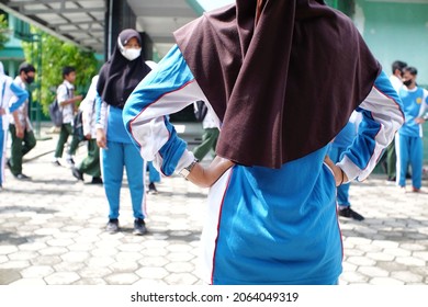 Cilacap, Indonesia. October 19, 2021. Group Of Students Wearing Mask Are Doing Physical Exercise At School Yard. Due To Covid-19 Health Protocols, Student Must Always Use Health Mask At School.