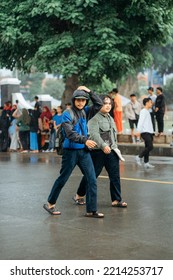 Cilacap, Indonesia, September 2022 - Two People Walking Fast When It Starts To Rain In A City