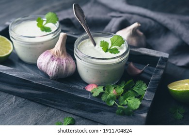Cilantro garlic sauce with lime juice and olive oil in a glass jar