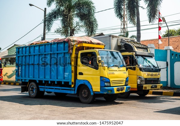Cilegon, Indonesia - August\
2, 2019: Trucks passed by the street loaded with shipping materials\
or cargo