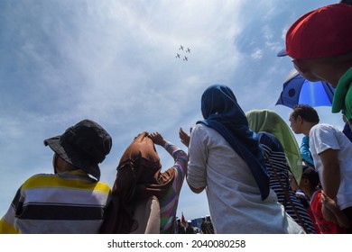 Cilegon, Indonesia - October 05, 2017 : Happy Family Watching Airplane Show In Order To Celebrate The Indonesian National Armed Forces Day