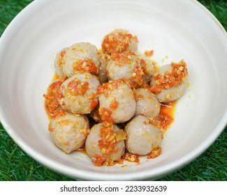 Cilok is made from tapioca or aci flour and served by plugging, cilok is a round shaped snack with a chewy texture and served with chili sauce - Shutterstock ID 2233932639