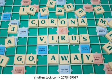 Cimone, Indonesia, November 16, 2021: Scrabble Tiles Writing CORONA VIRUS GO AWAY On Scrabble Board. Education And Learning Concept.