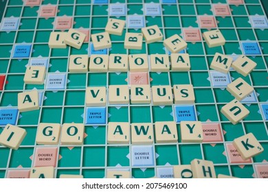 Cimone, Indonesia, November 16, 2021: Scrabble Tiles Writing CORONA VIRUS GO AWAY On Scrabble Board. Education And Learning Concept.