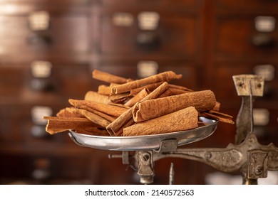 Cinamon Stick Roll Asian Dry Herb And Food Aroma From Tree Bark Placed At Weight Scale In Chinese Medicine Shop.