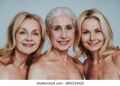 Cincematic Image Of A Beautiful Senior Women Group Posing On A Beauty Photo Session. Middle Aged Women In Lingerie On A Grey Background. Concept About Body Positivity, Self Esteem And Body Acceptance